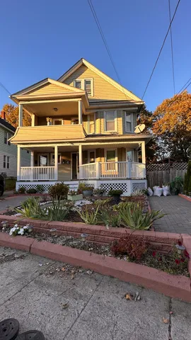 a front view of a house with a garden