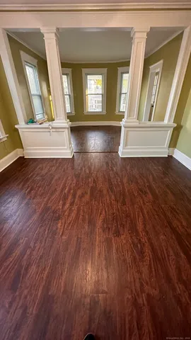 a view of an entryway with wooden floor and door