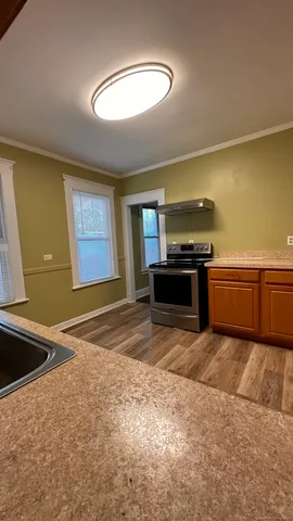 a kitchen with stainless steel appliances granite countertop a sink and a stove top oven