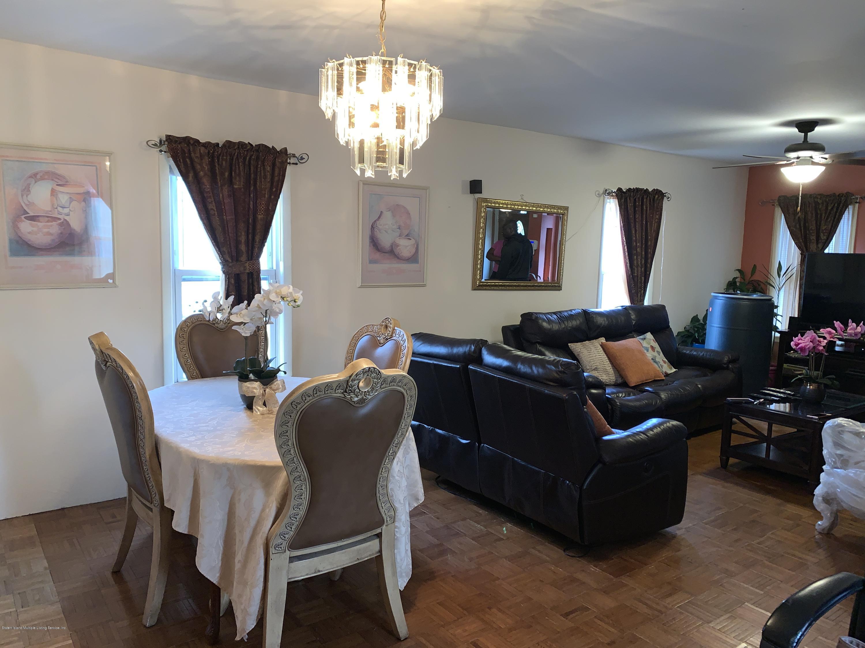 7 Lockman Place Staten Island, NY 10303 - Photo 14 of 41 a living room with furniture chandelier and a window