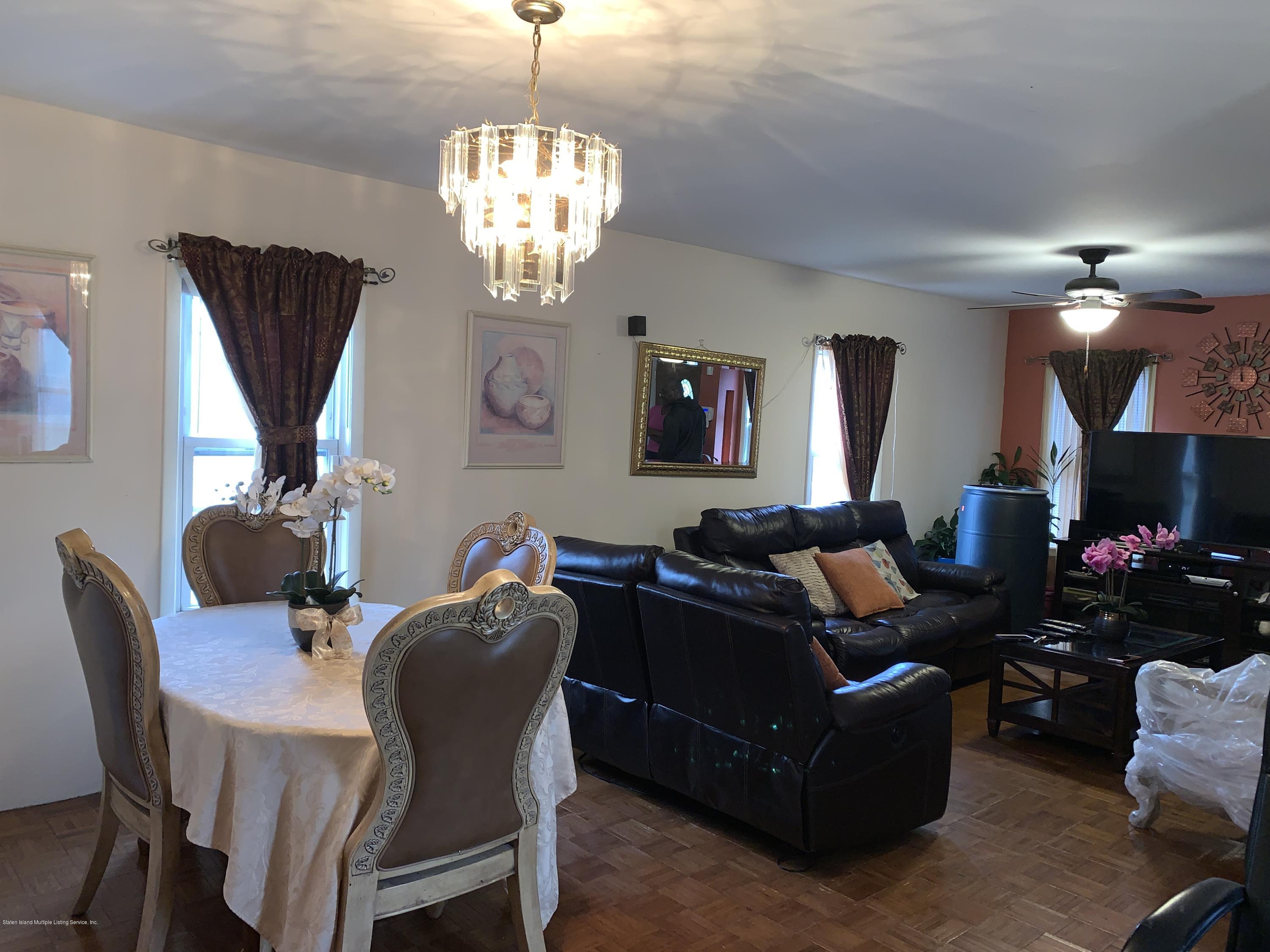 7 Lockman Place Staten Island, NY 10303 - Photo 15 of 41 a living room with furniture chandelier and a flat screen tv