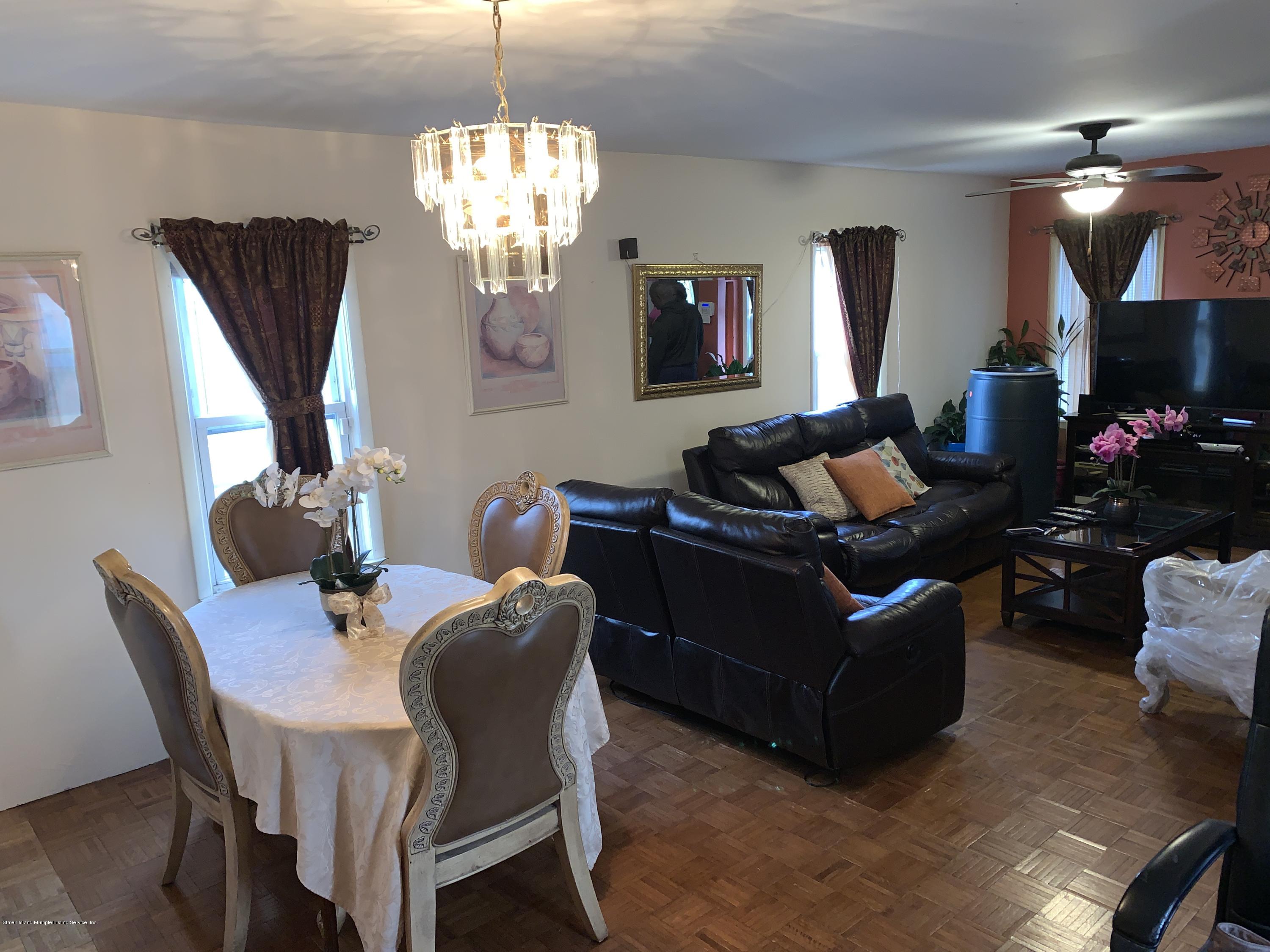 7 Lockman Place Staten Island, NY 10303 - Photo 17 of 41 a living room with furniture chandelier and a fireplace