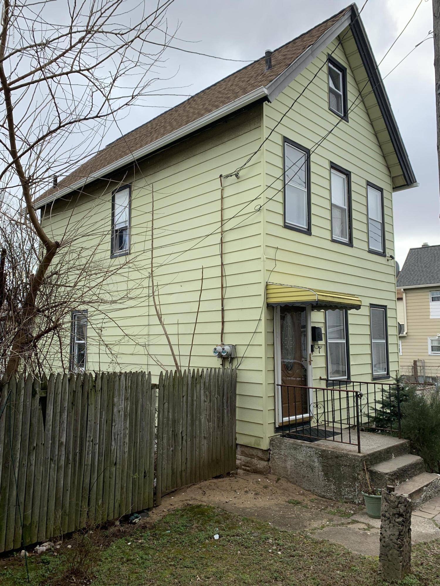 7 Lockman Place Staten Island, NY 10303 - Photo 2 of 41 a view of a house with a yard and wooden fence