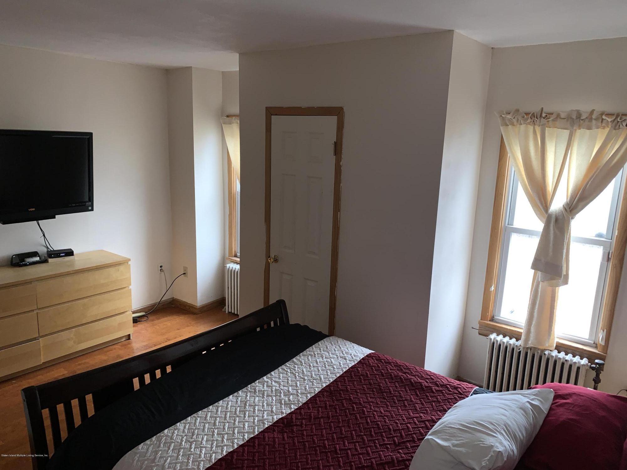 7 Lockman Place Staten Island, NY 10303 - Photo 21 of 41 a bedroom with a bed and a flat screen tv