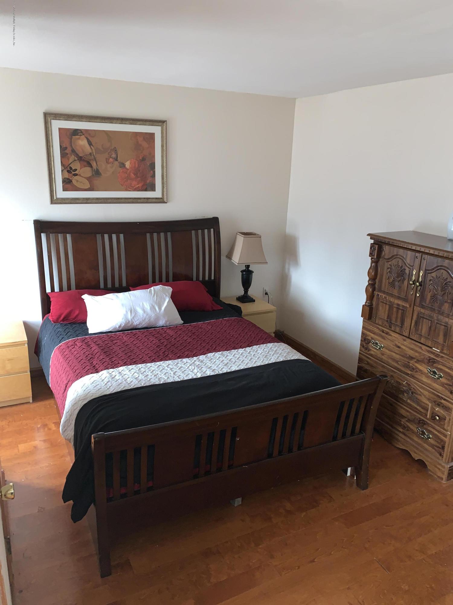 7 Lockman Place Staten Island, NY 10303 - Photo 22 of 41 a bedroom with a bed and dresser