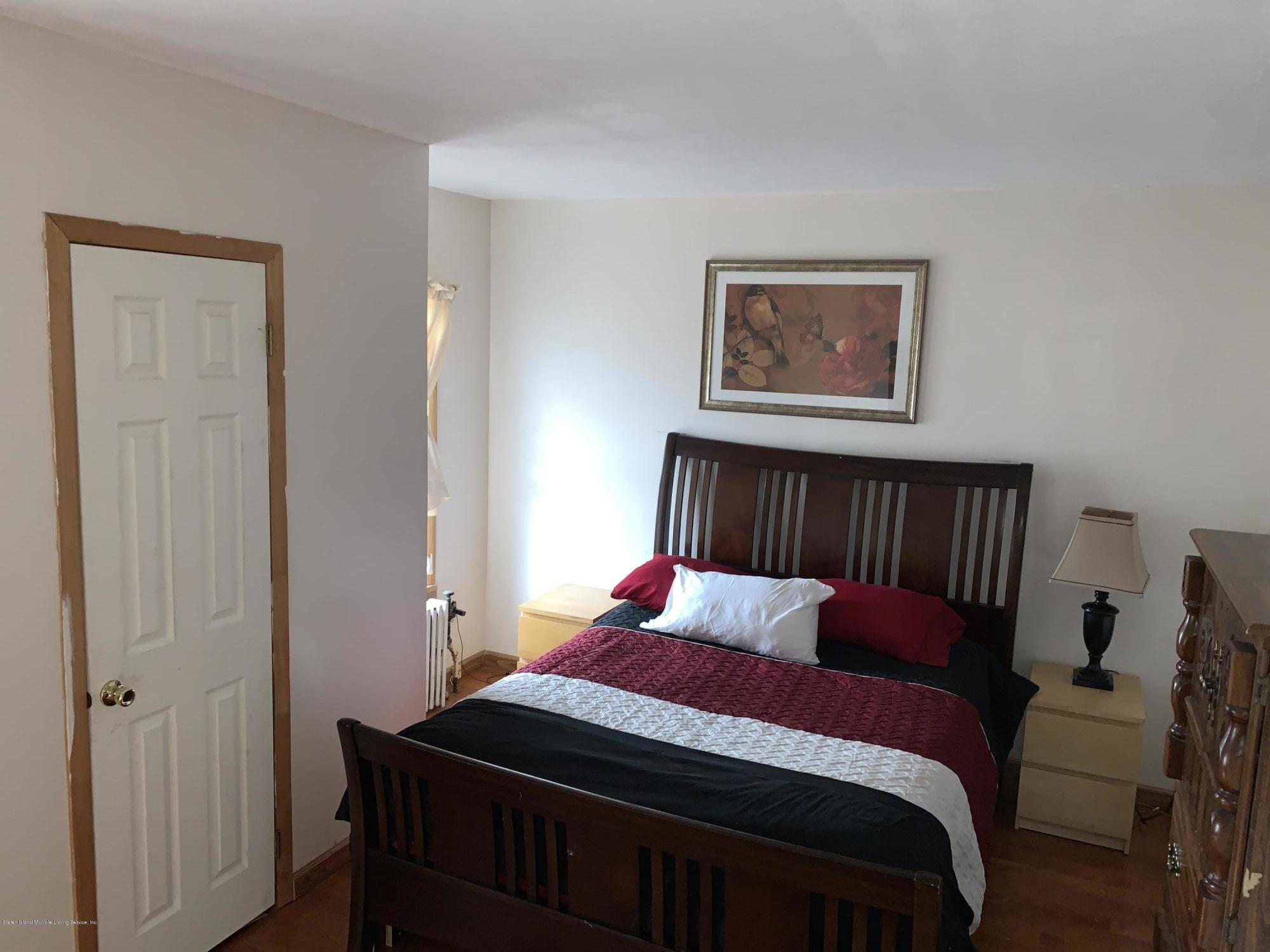 7 Lockman Place Staten Island, NY 10303 - Photo 23 of 41 a bedroom with a bed and a furniture