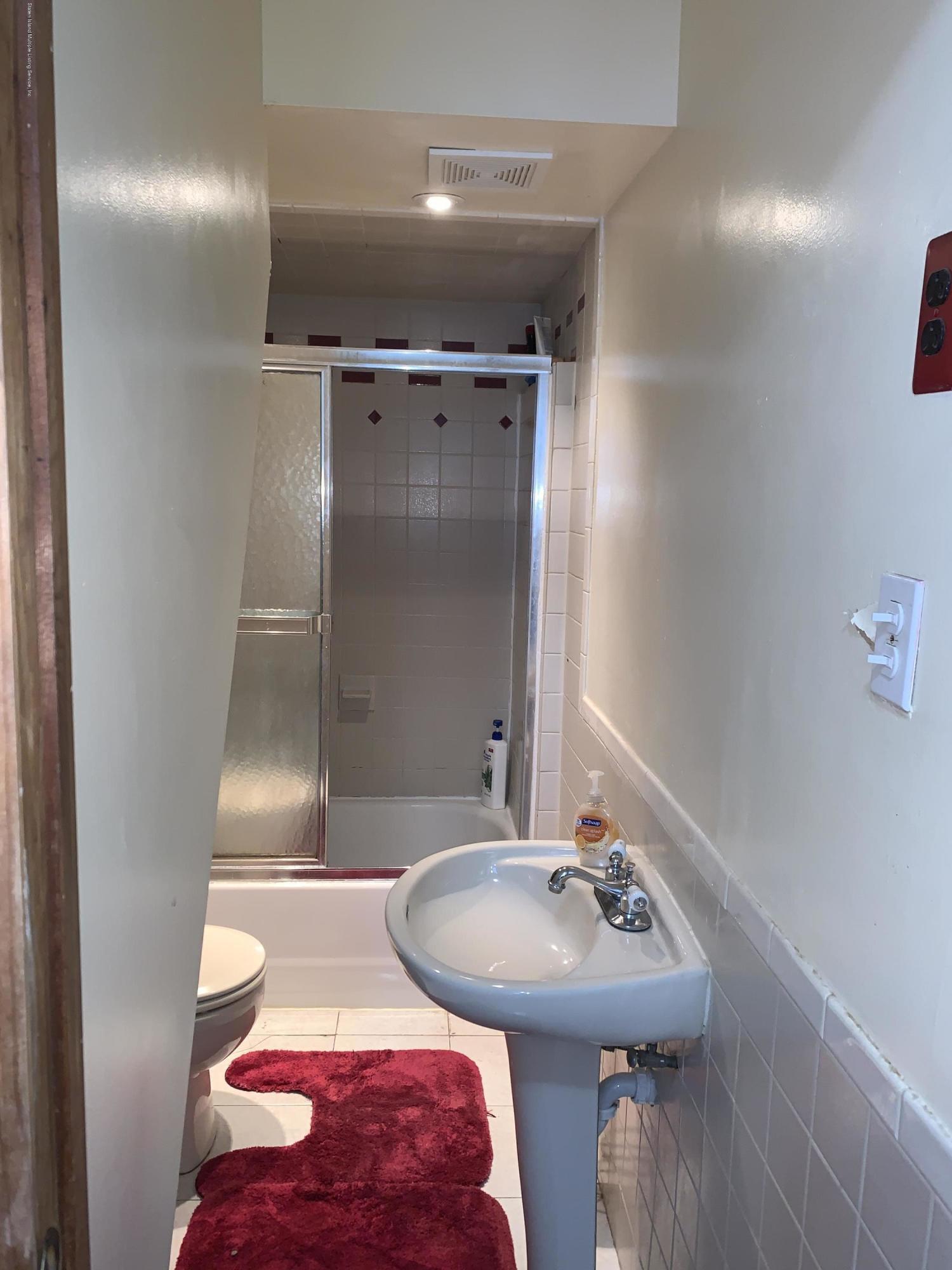 7 Lockman Place Staten Island, NY 10303 - Photo 25 of 41 a bathroom with a sink and a mirror