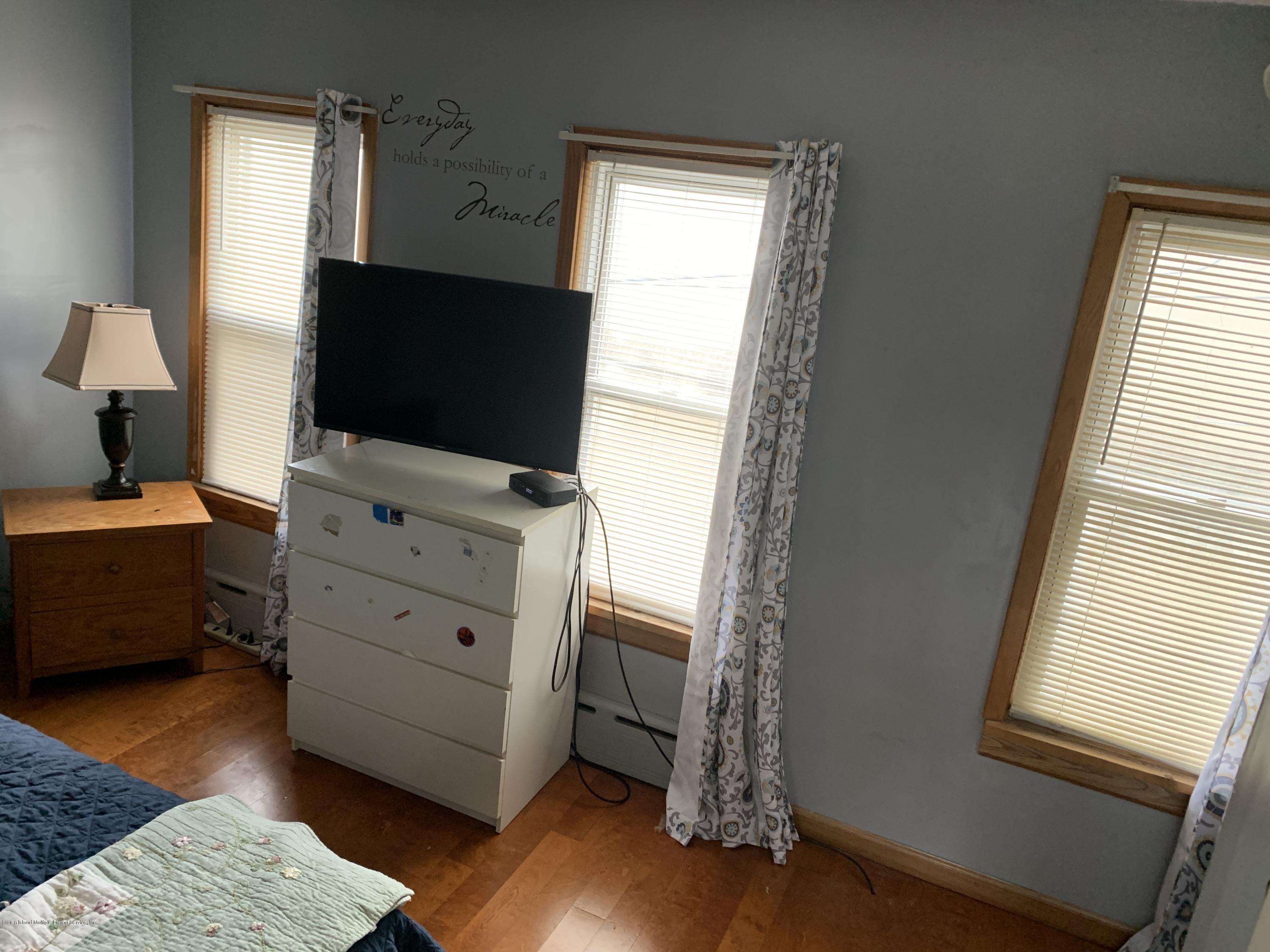 7 Lockman Place Staten Island, NY 10303 - Photo 27 of 41 a room with furniture and flat screen tv