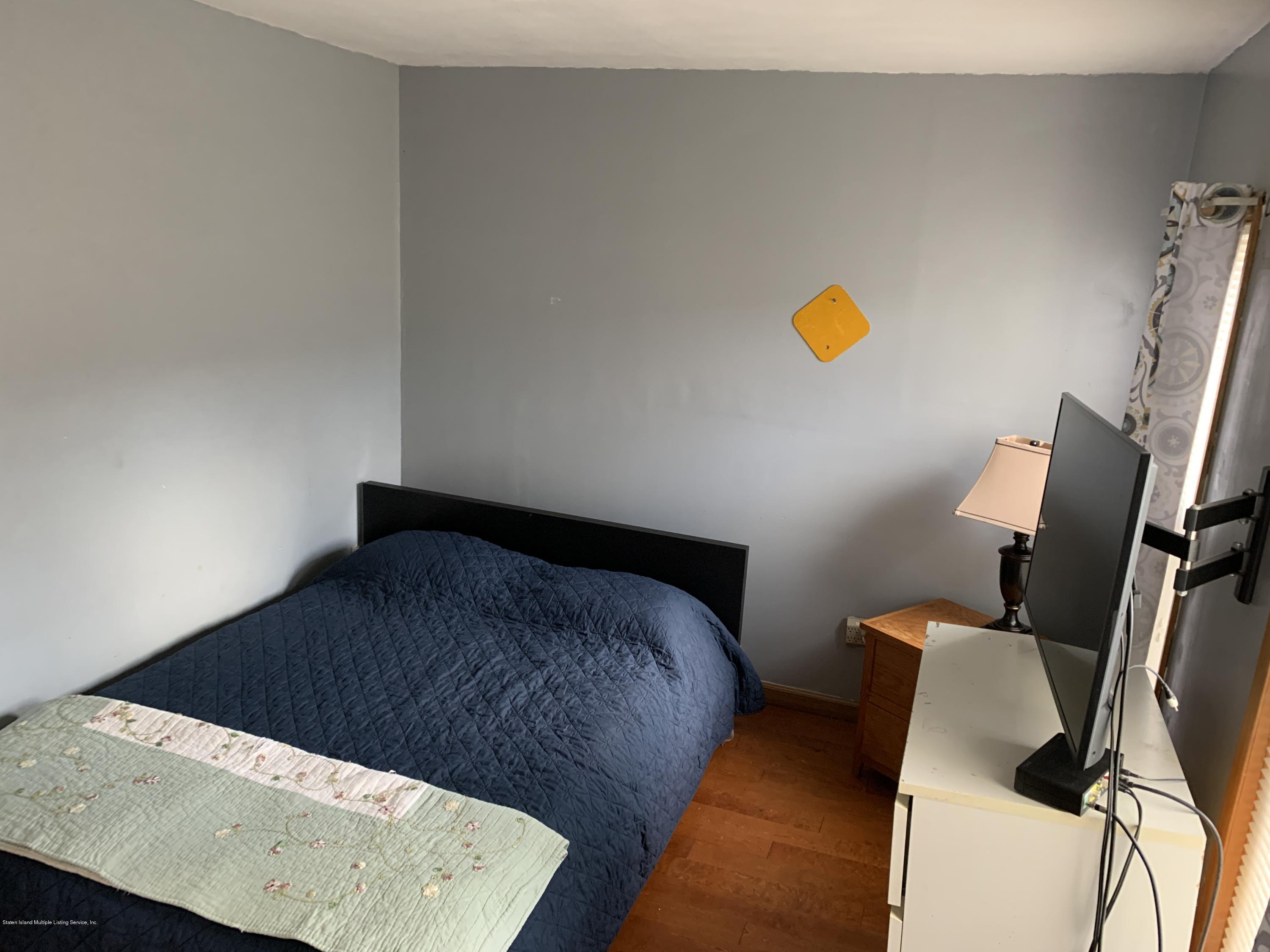 7 Lockman Place Staten Island, NY 10303 - Photo 28 of 41 a bedroom with a bed and teddy bear on bed