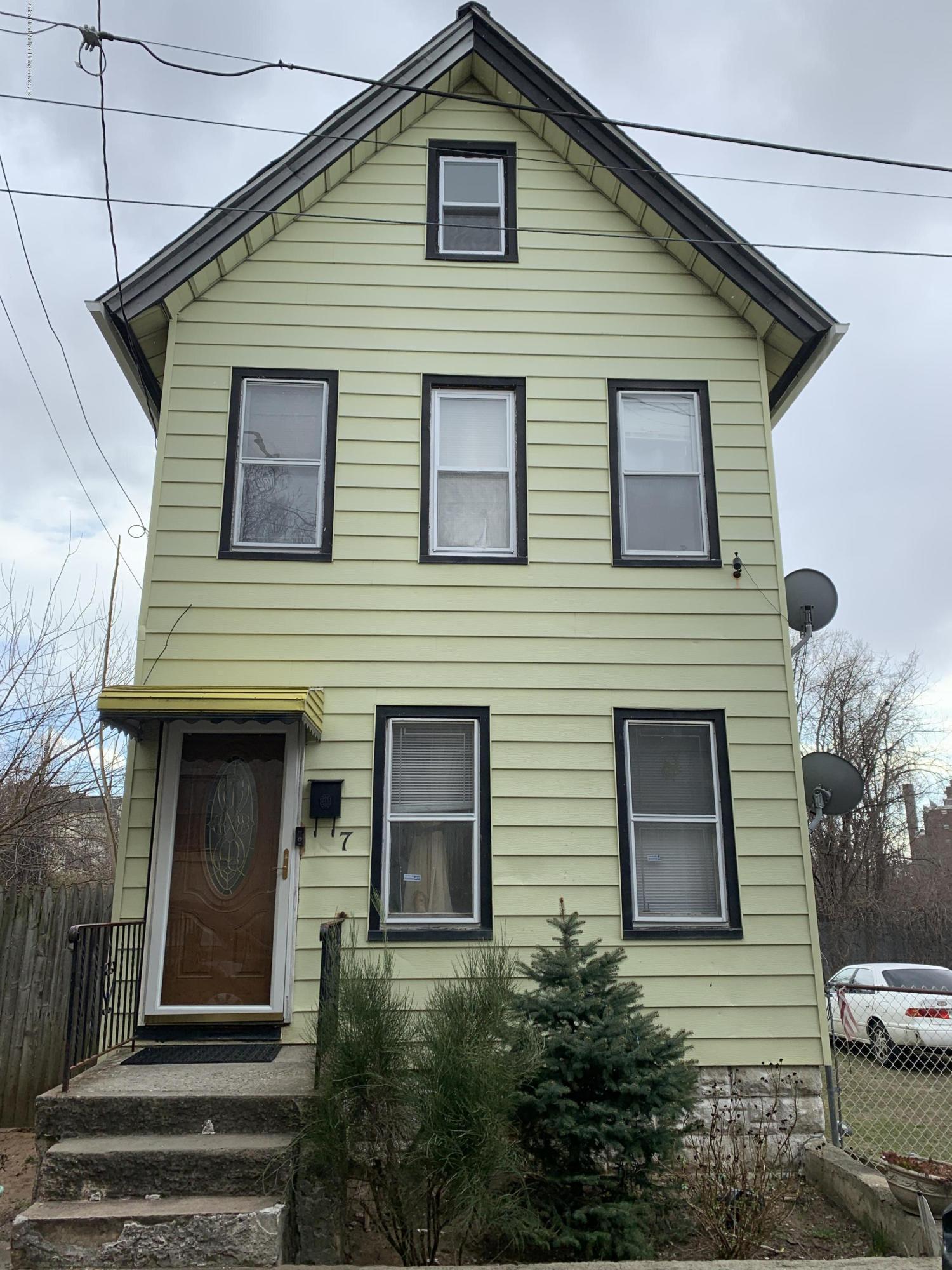 7 Lockman Place Staten Island, NY 10303 - Photo 3 of 41 a front view of a house with a yard