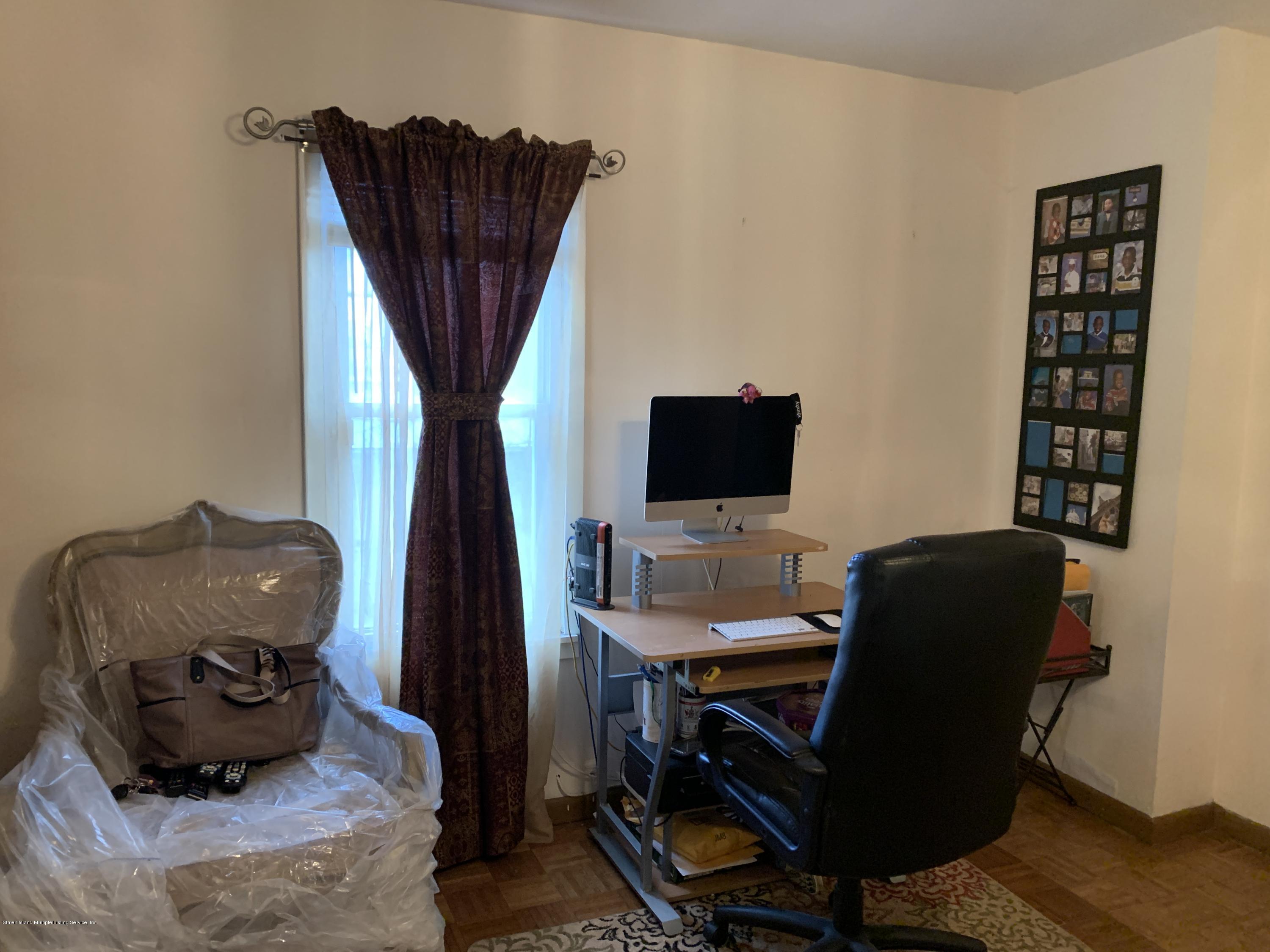 7 Lockman Place Staten Island, NY 10303 - Photo 35 of 41 a living room with furniture and a flat screen tv