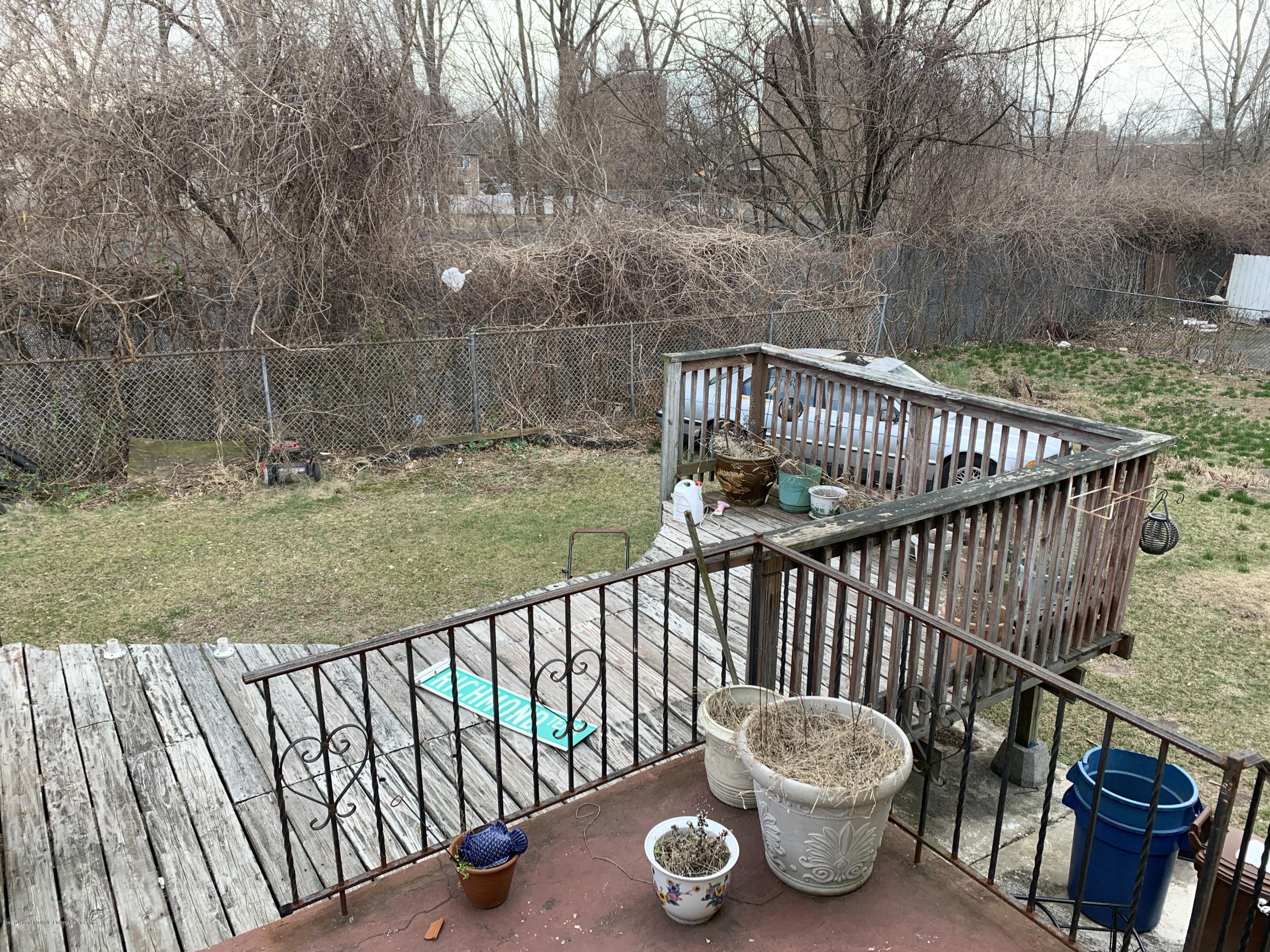 7 Lockman Place Staten Island, NY 10303 - Photo 36 of 41 a view of a deck with a chair and wooden fence