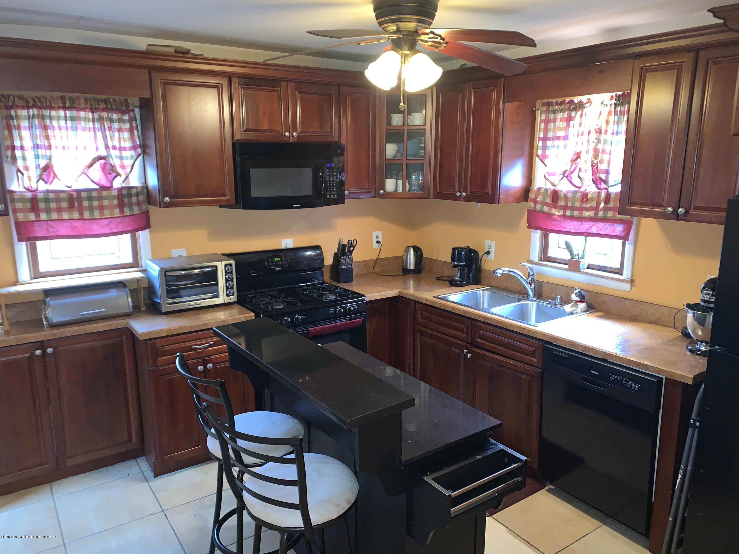 7 Lockman Place Staten Island, NY 10303 - Photo 6 of 41 a kitchen with a sink cabinets and window
