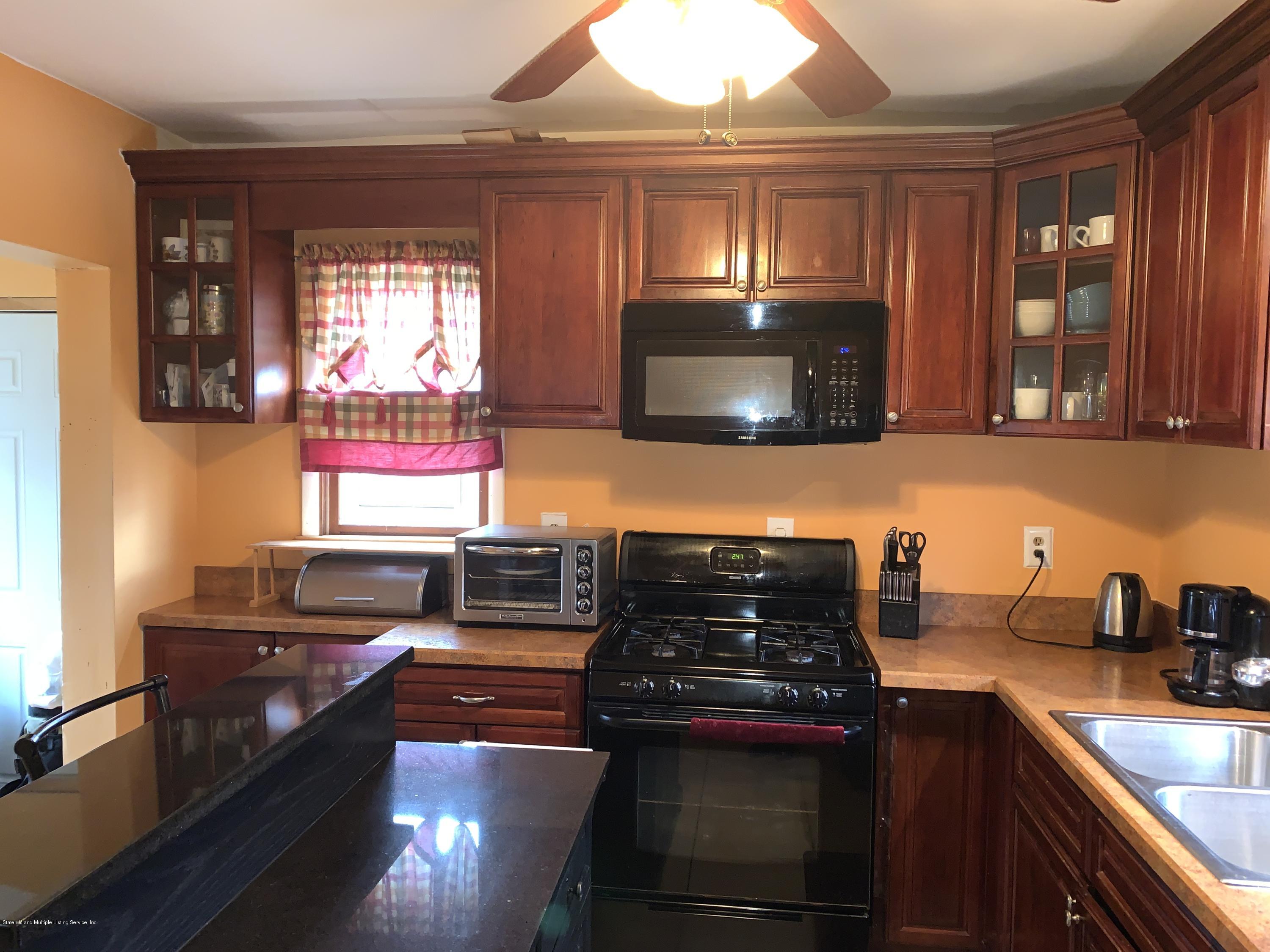 7 Lockman Place Staten Island, NY 10303 - Photo 9 of 41 a kitchen with a stove and a microwave