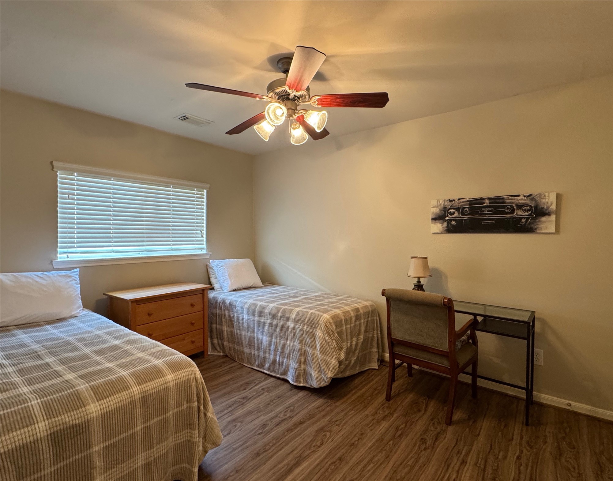 21818 Saragosa Pond Lane Spring, TX 77379 - Photo 13 of 15 Bedroom 2 has twin beds and a ceiling fan.