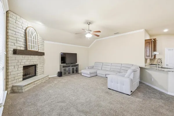 a spacious bedroom with a large bed and a chandelier fan