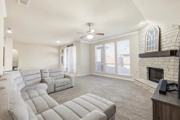 a bedroom with a bed a ceiling fan and a dresser