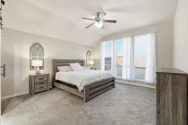 a bathroom with a tub a sink and glass door
