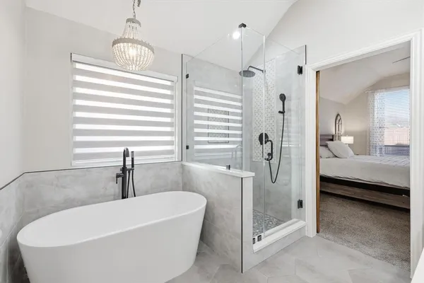 a bathroom with a double vanity sink mirror and shower