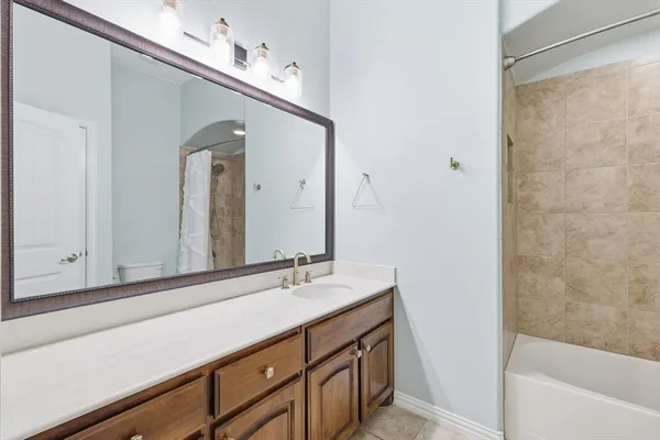 an empty room with chandelier fan