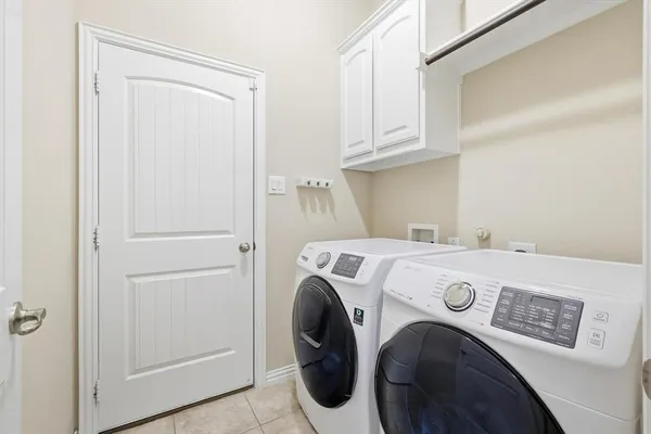 a view of a house with a big yard and large trees