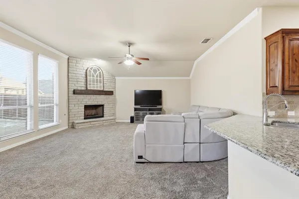 a living room with furniture fireplace and a large window