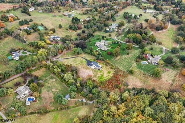 an aerial view of a house with a big yard