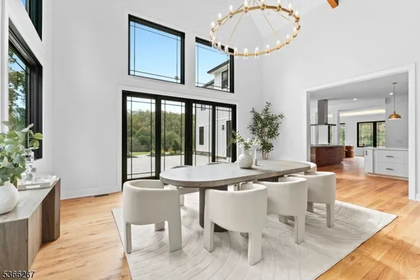 a view of a kitchen with kitchen island stainless steel appliances wooden floor and living room view