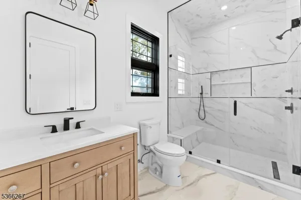 a view of staircase with railing and a chandelier