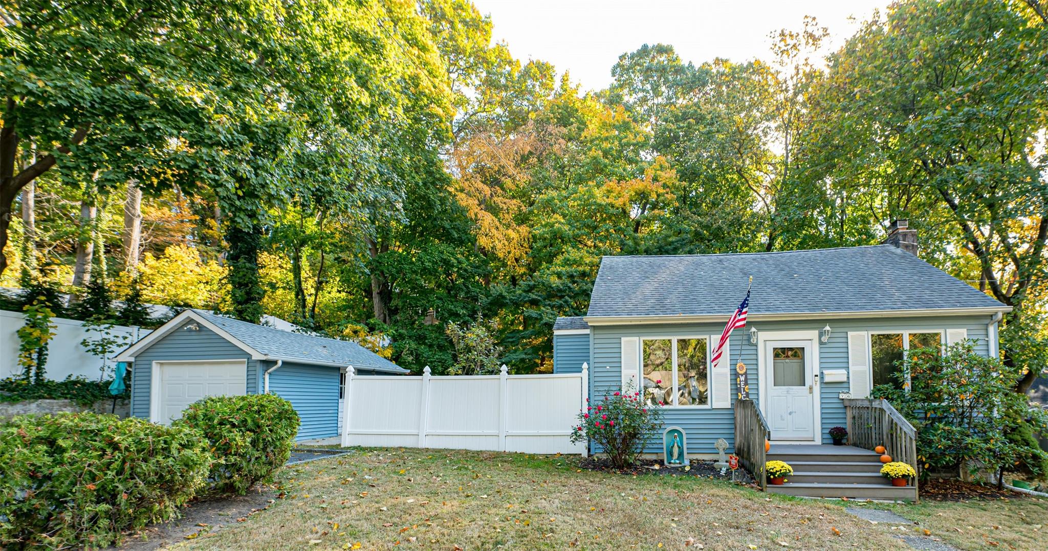 76 North Woodhull Road Huntington, NY 11743 - Photo 1 of 1 View of front of house featuring an outbuilding, a garage, and a front yard