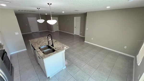 a view of a kitchen with a sink and microwave