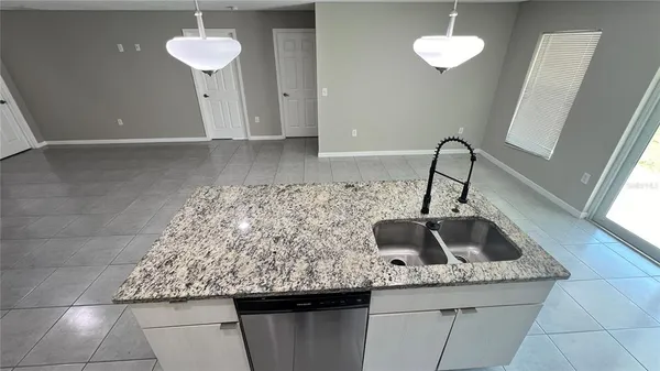 a kitchen with sink and a window