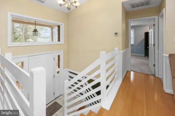 a view of an entryway with wooden floor