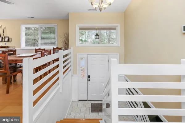 a view of a bedroom with wooden floor and windows