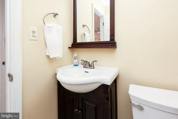 a bathroom with a sink a toilet and mirror
