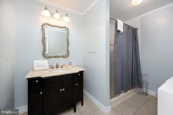 a bathroom with a sink a mirror and a shower