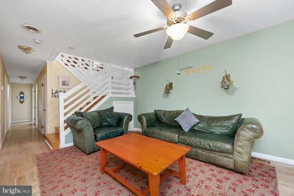 a living room with furniture and a dining table