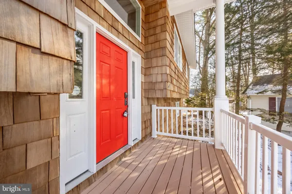 a view of a balcony with wooden floor and fence