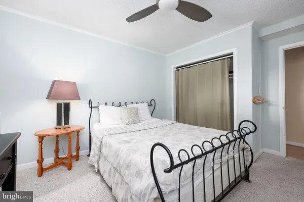a bedroom with a bed and a lamp on table