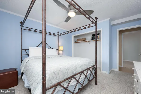 a bed room with a bed and a chandelier