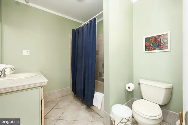 a white toilet sitting next to a bathroom sink