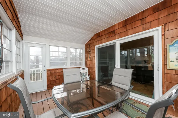a dining room with furniture and wooden floor