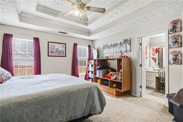 a bedroom with a bed and a flat tv screen