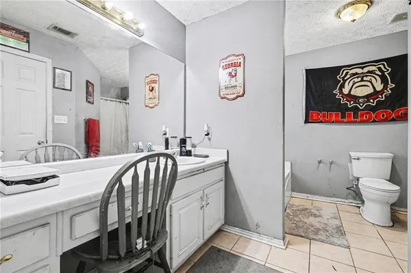 a bathroom with a sink a toilet and a shower