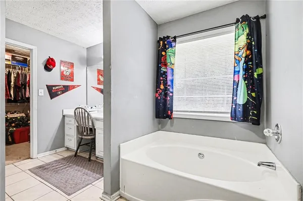 a bathroom with a tub and a window