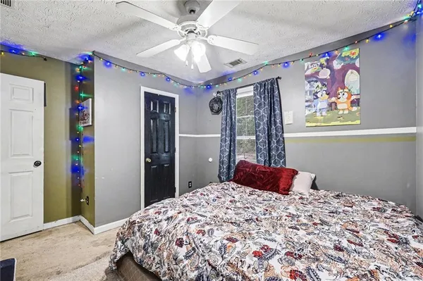 a bedroom with a bed and a chandelier
