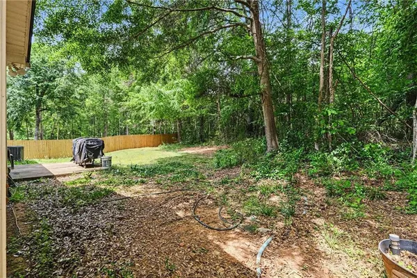 a backyard of a house with a yard and outdoor seating