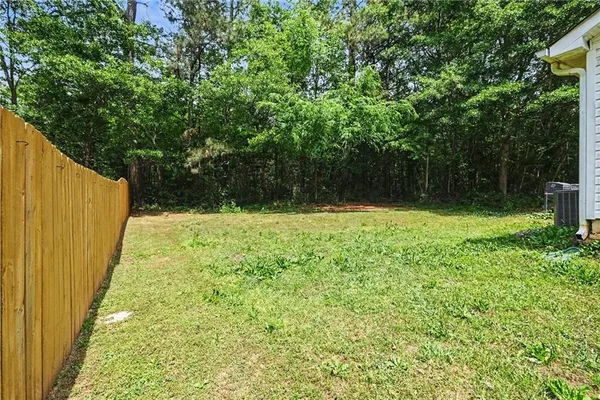a view of outdoor space with a garden and trees