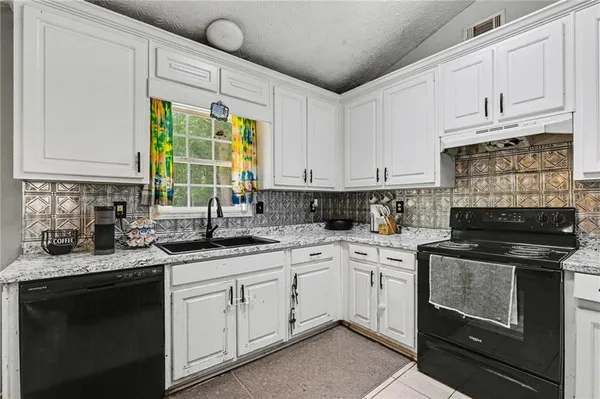 a kitchen with a sink stove and cabinets