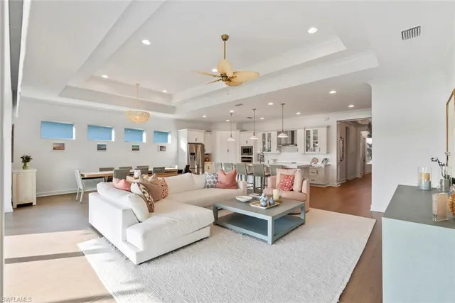 a living room with furniture and kitchen view